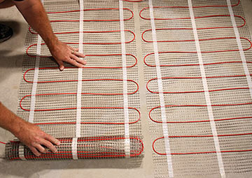 ComfortTile floor heating mats being installed.